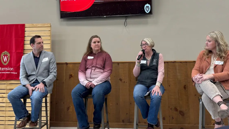 A group of four people sit on a panel answering questions during the VITAL Conference.